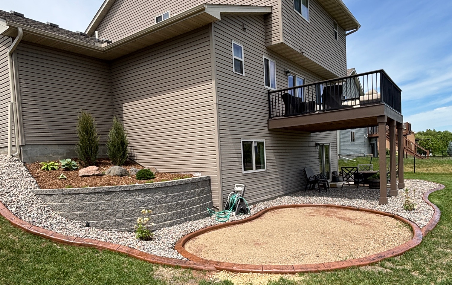 After - stamped concrete curbing and stone retaining wall